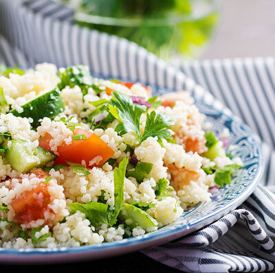 Tabbouleh is a salad of Arabic or Middle Eastern origin that is made with bulgur, garlic, parsley, mint, tomatoes, scallions, and onions.